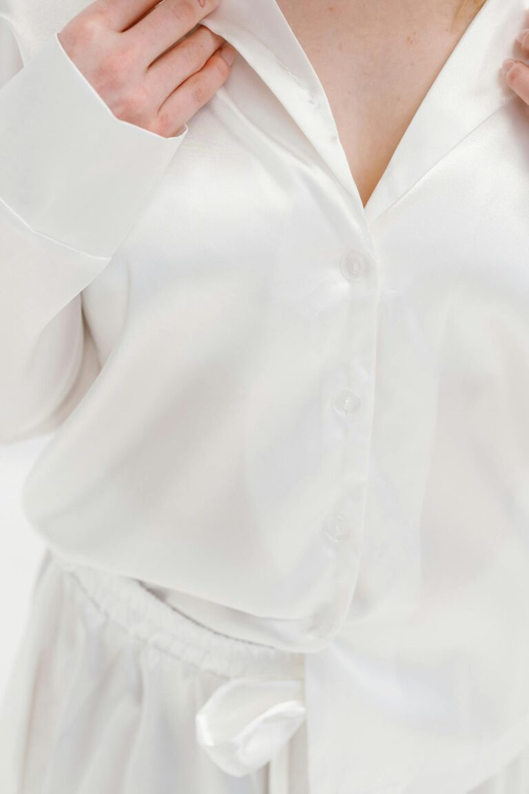 Close-up of luxurious white silk sleepwear highlighting elegance and comfort.
