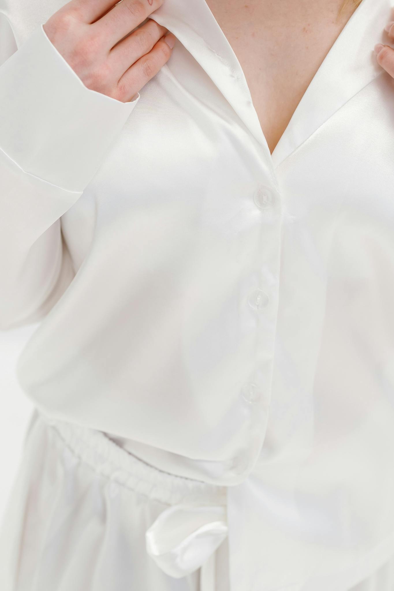 Close-up of luxurious white silk sleepwear highlighting elegance and comfort.