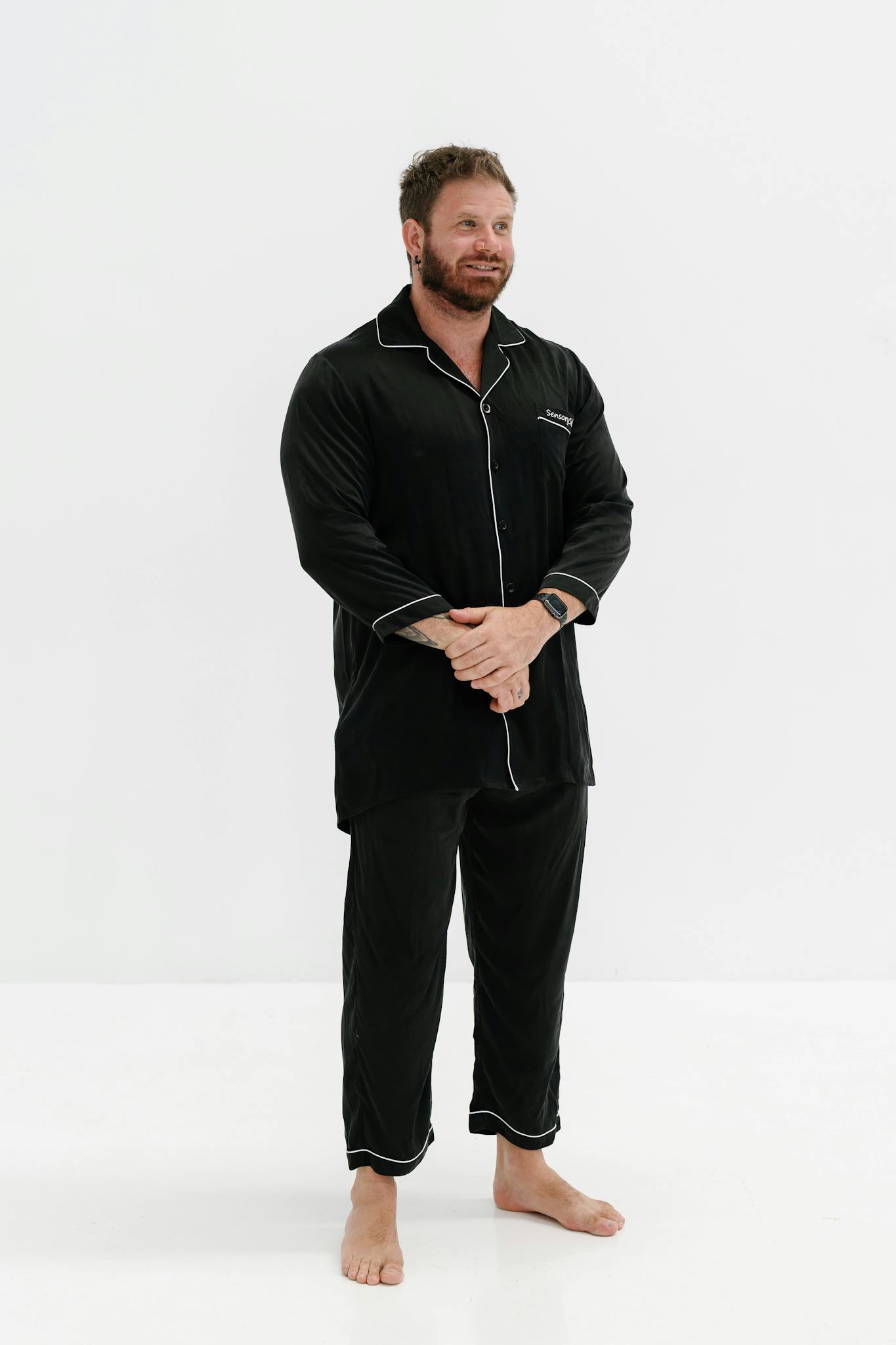 Stylish men's pajama set in black with contrast piping, perfect for comfortable nights.